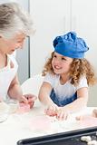 A little girl  baking with her grandmother 