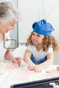 A little girl  baking with her grandmother 