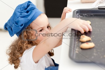 Little girl stealing cookies 