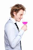 Young man drink pink wine.