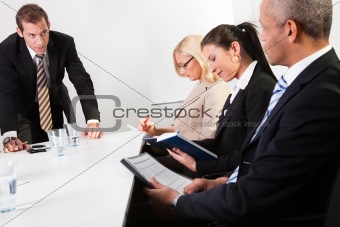 Team of business people taking notes