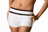 Torso and hips of woman in white shorts bare belly