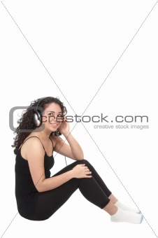 cute hispanic girl smiling while listening to music on headphone