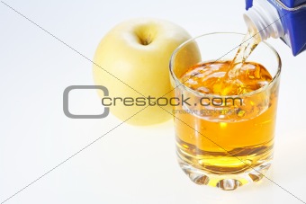 Yellow apple and glass of juice