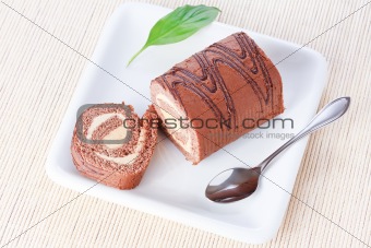 Swiss roll with condensed milk cream and a green leaf