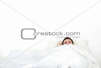 Alone young man in a bed