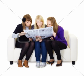 Three girlfriends teen read the newspaper