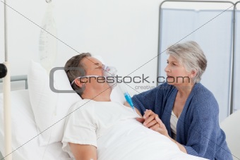 Old women taking care of her husband