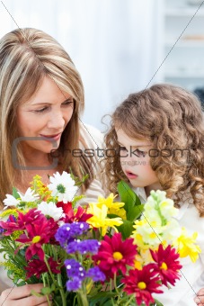 Grandmother with a little girl taking flowers