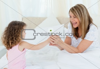 Little girl offering a gift to her grandmother
