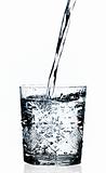Water pouring in a glass, white background 