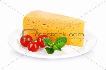 yellow cheese in plate with tomatoes and leaf