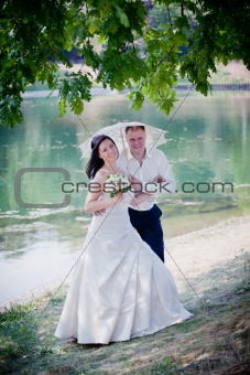 Newlyweds portrait in sunny summer park
