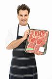 Butcher with tray of steak