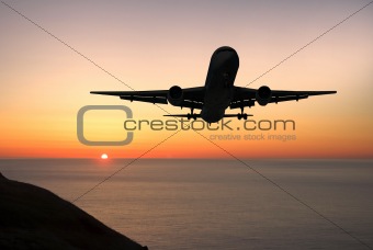 Airliner landing at sunrise