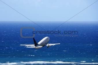 Airplane over ocean.