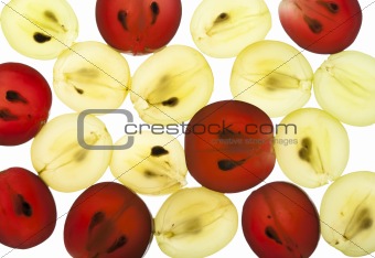 Transparent slices of red and yellow grapes