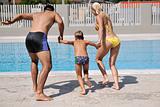 happy young family have fun on swimming pool