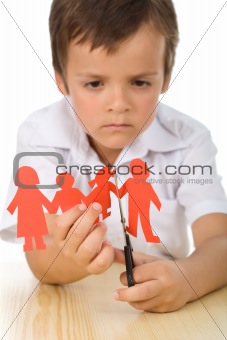 Sad boy cutting paper people family - divorce concept