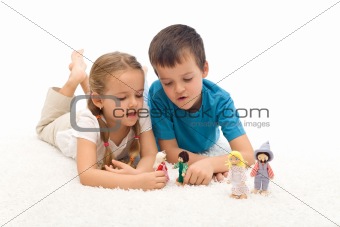 Kids playing with puppets laying on the floor