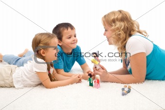 Woman telling a story to her kids on the floor