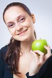 beautiful young woman holding an apple