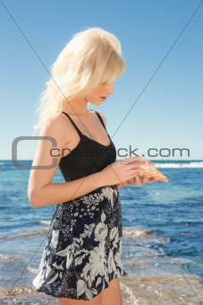 young woman on reef at sea