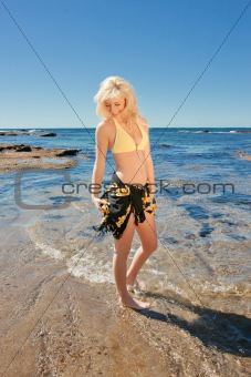 young woman on reef at sea