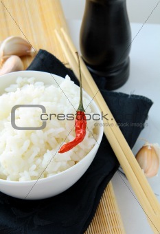 bowl of white fluffy rice with chopsticks