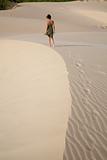 woman walking at sand curve