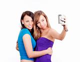 two young women taking pictures with digital camera - isolated on white