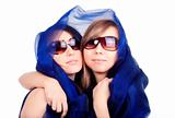two young women standing covered with blue scarf - isolated on white