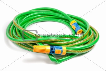 Green and yellow garden water hose with yellow sprinkler on white