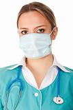 Portrait of female doctor in mask with stethoscope. isolated on 