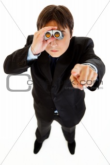Serious businessman looking through binoculars and pointing finger at you
