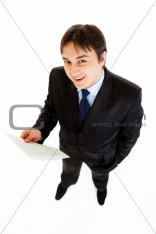 Smiling modern businessman holding financial document  in hand 
