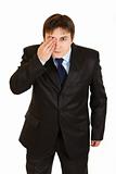 Attentive businessman closed his eyes with his hand
