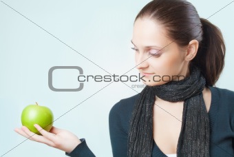 Beautiful young lady with green apple