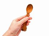 Hand holds a wooden spoon