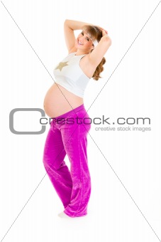 Smiling beautiful pregnant woman doing exercise
