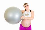 Happy beautiful pregnant woman  in sportswear holding fitness ball 
