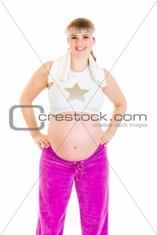 Smiling beautiful pregnant woman  in sportswear holding towel
