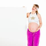 Happy beautiful pregnant woman holding blank billboard
