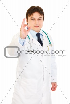 Smiling medical doctor showing ok gesture
