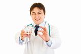Smiling  medical doctor with tablet and glass of water in hands
