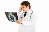 Concentrated medical doctor holding results of pelvis roentgen
