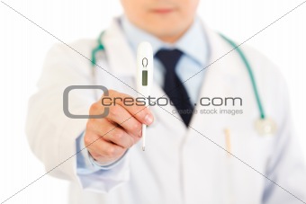 Doctor holding medical thermometer. Close-up.
