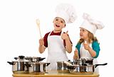 Happy chef and his aid - kids with cooking utensils isolated