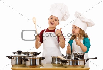 Happy chef and his aid - kids with cooking utensils isolated
