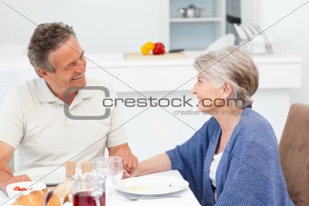 Retired couple eating in the kitchen
